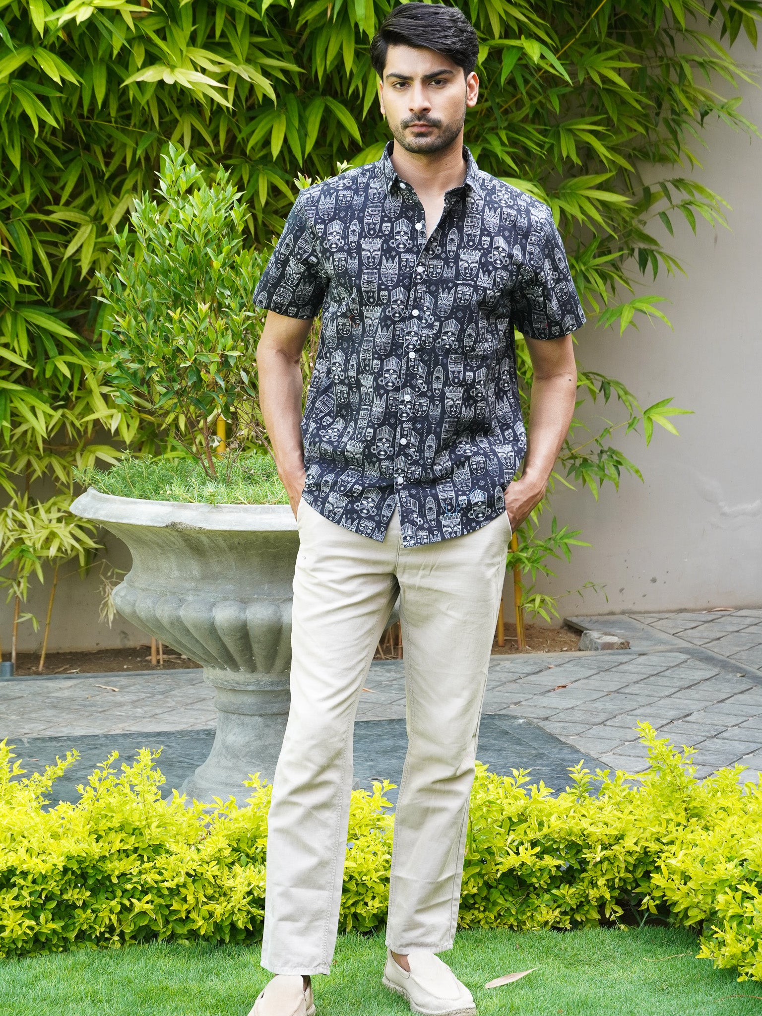Model wearing men’s black tribal art print half sleeve shirt