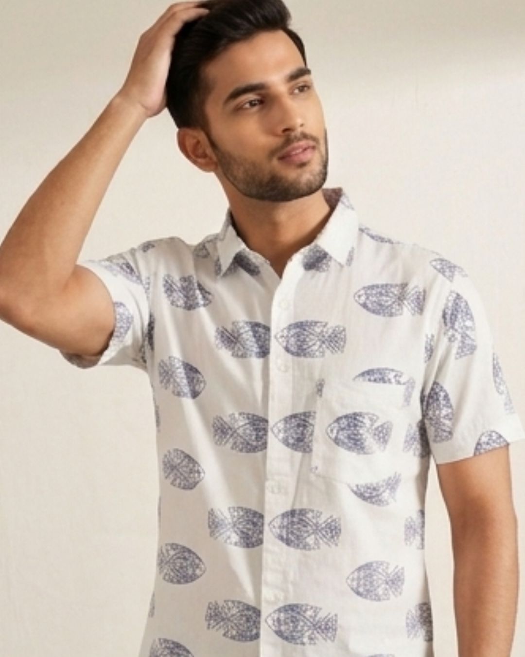 Close-up of blue fish motifs on white shirt fabric