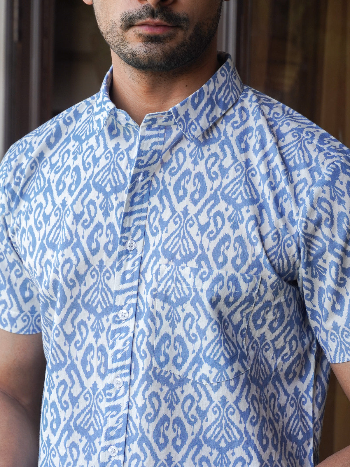 Close-up of indigo-blue abstract geometric motifs on light fabric