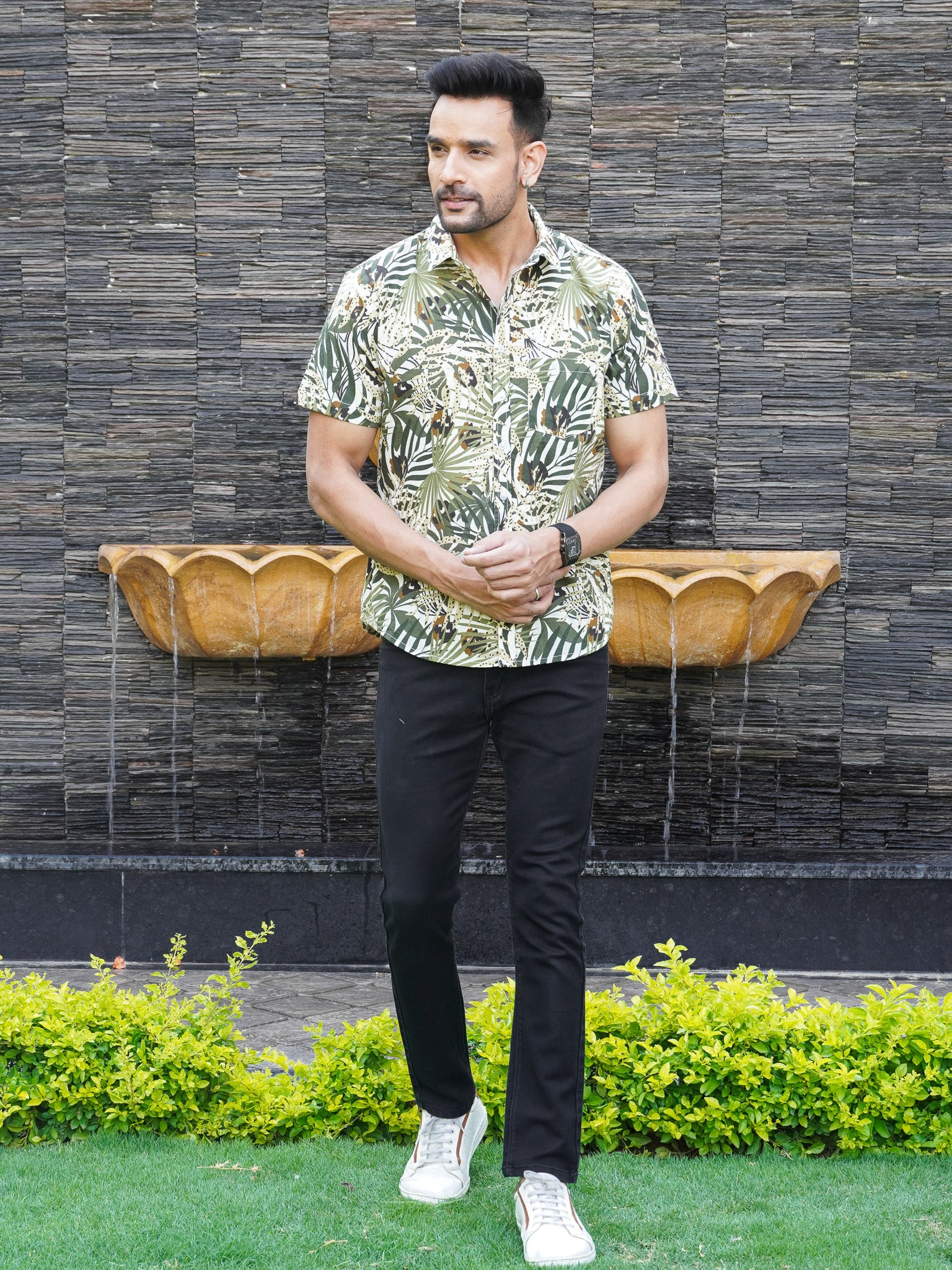 Model wearing men’s green Urban Jungle leaf print half sleeve shirt