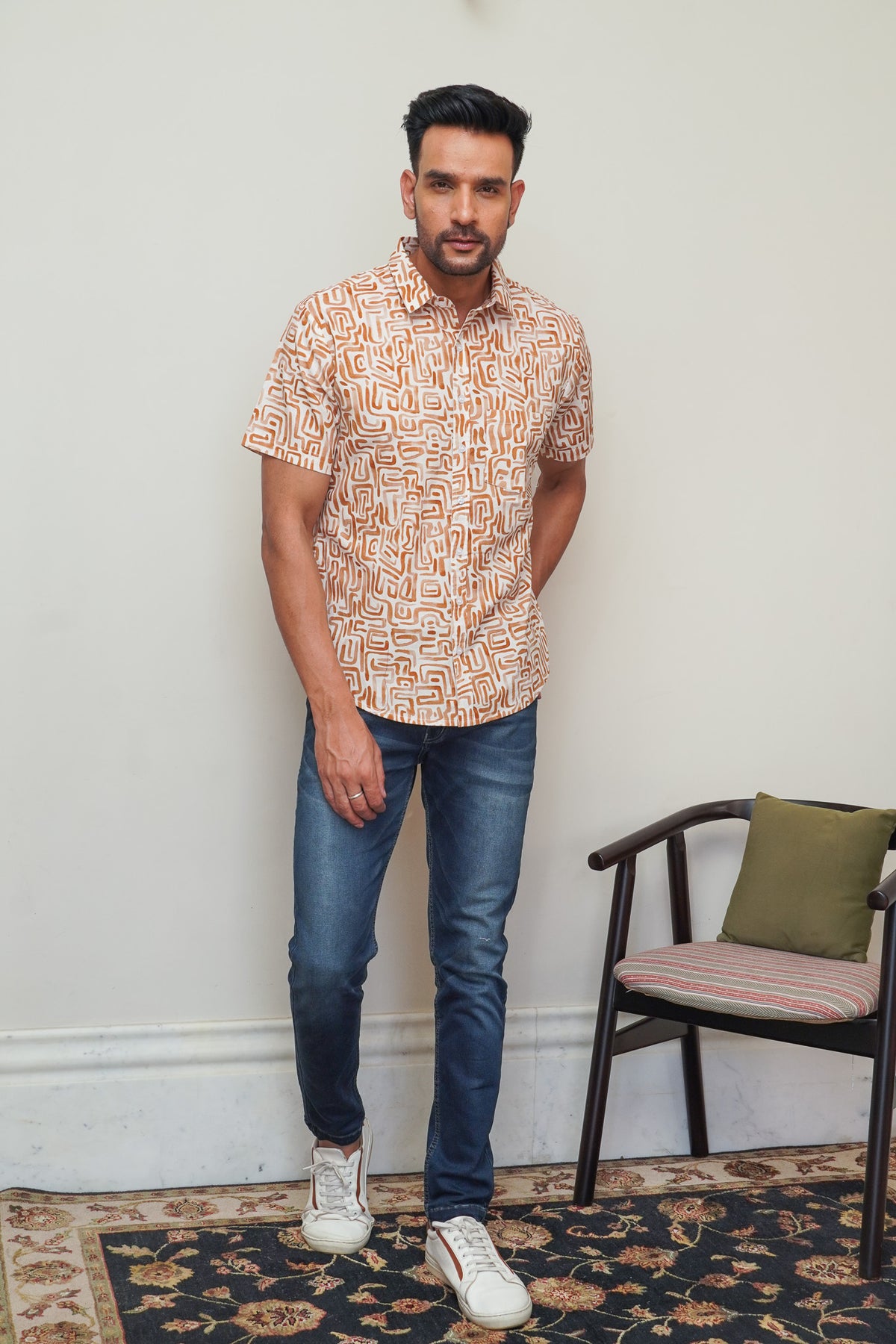 Model wearing men’s cream orange abstract box print half sleeve shirt