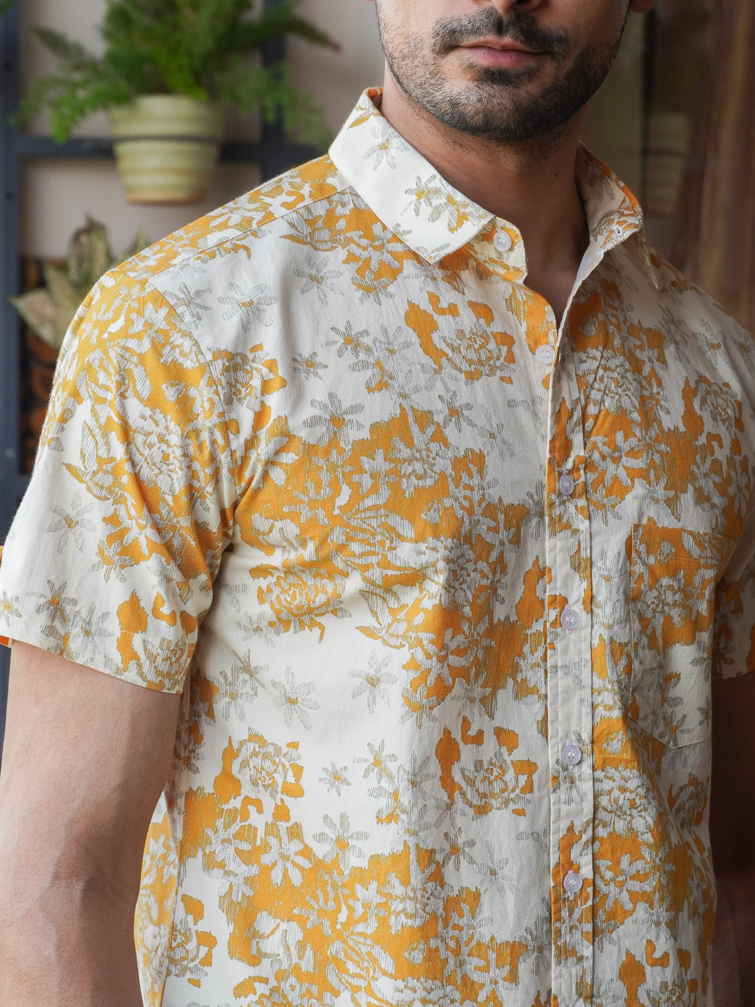 Close-up of cream and grey floral print on mustard cotton shirt