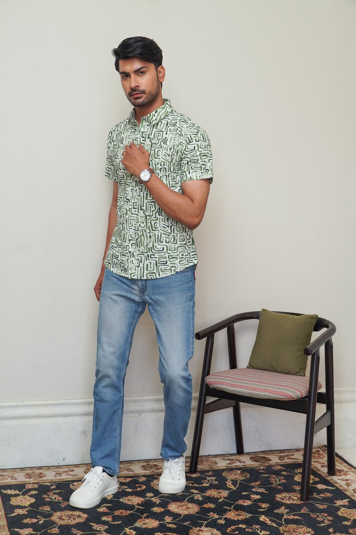 Model wearing a green abstract maze printed cotton half sleeve shirt