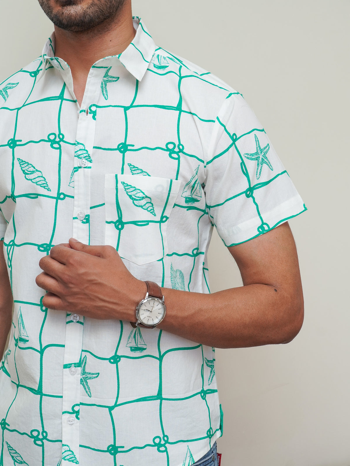 Close-up of green grid lines and abstract motifs on light cotton fabric