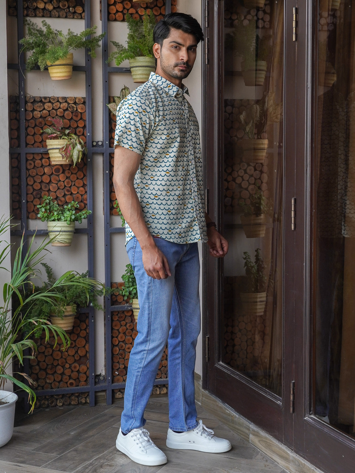 Model wearing a green floral printed cotton half sleeve shirt