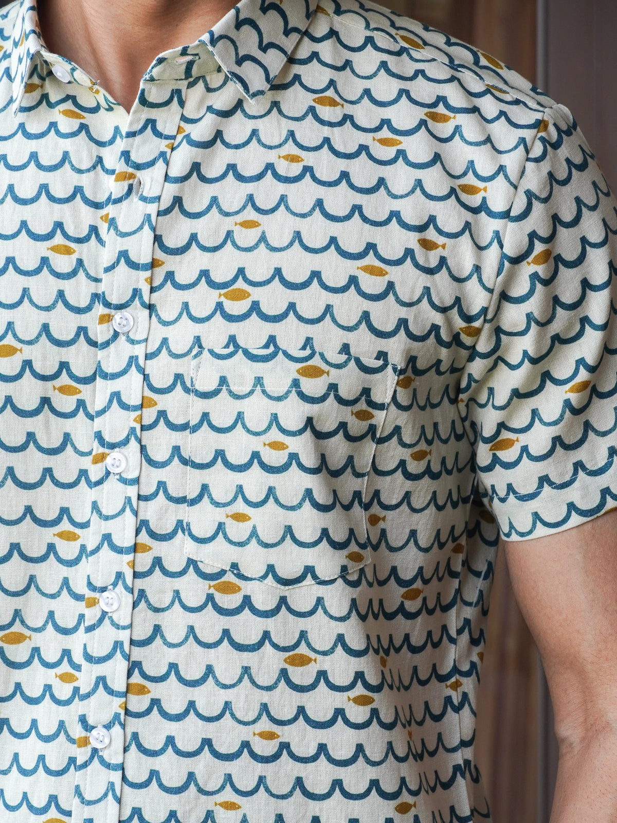 Close-up of green and navy decorative motifs on light fabric
