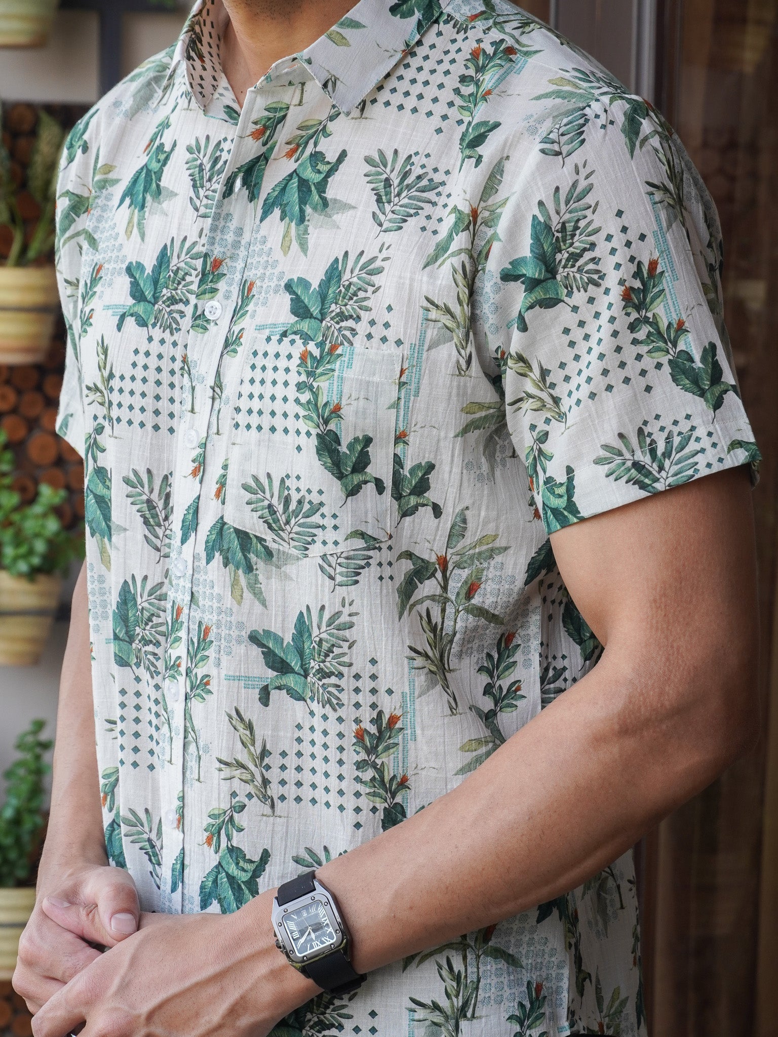 Close-up of leaf and lattice pattern on light green cotton shirt