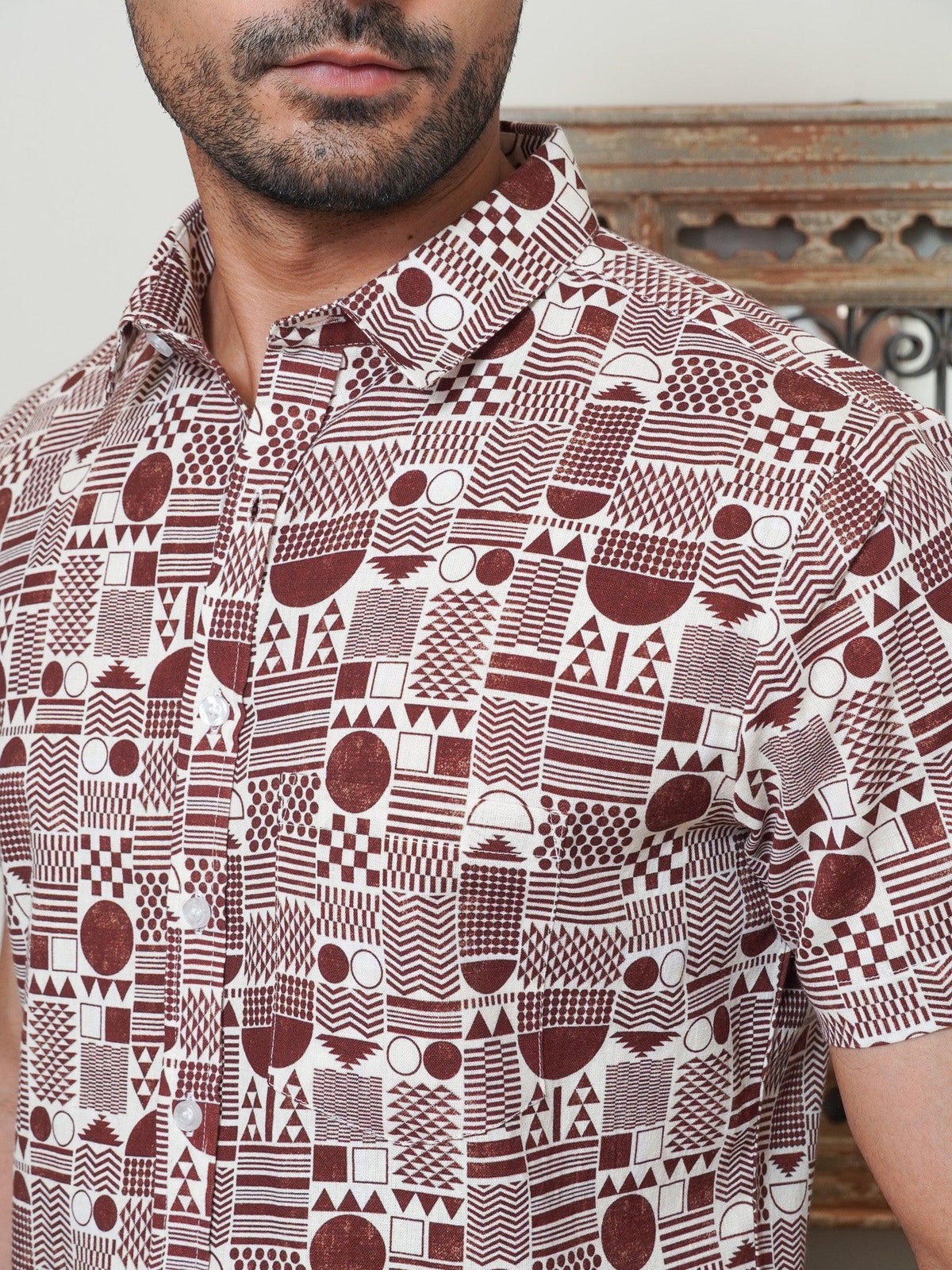 Close-up of maroon grids circles checks and stripe motifs