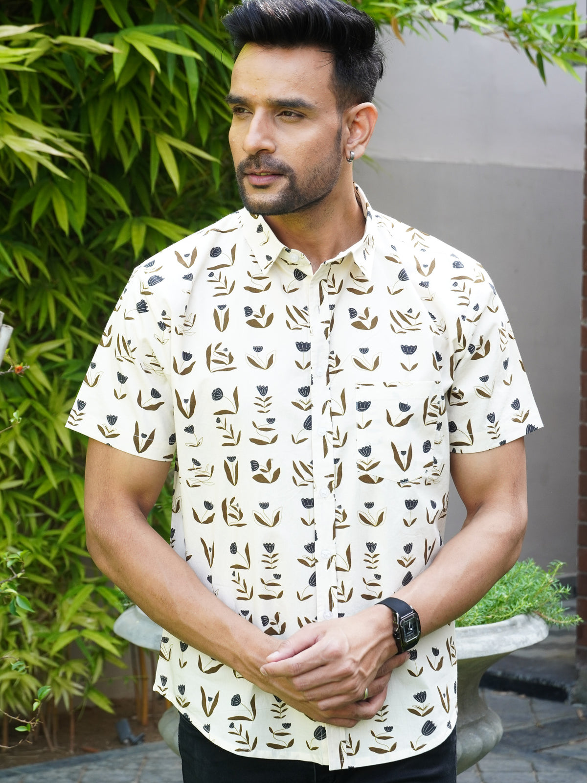 Model wearing a beige floral printed cotton half sleeve shirt