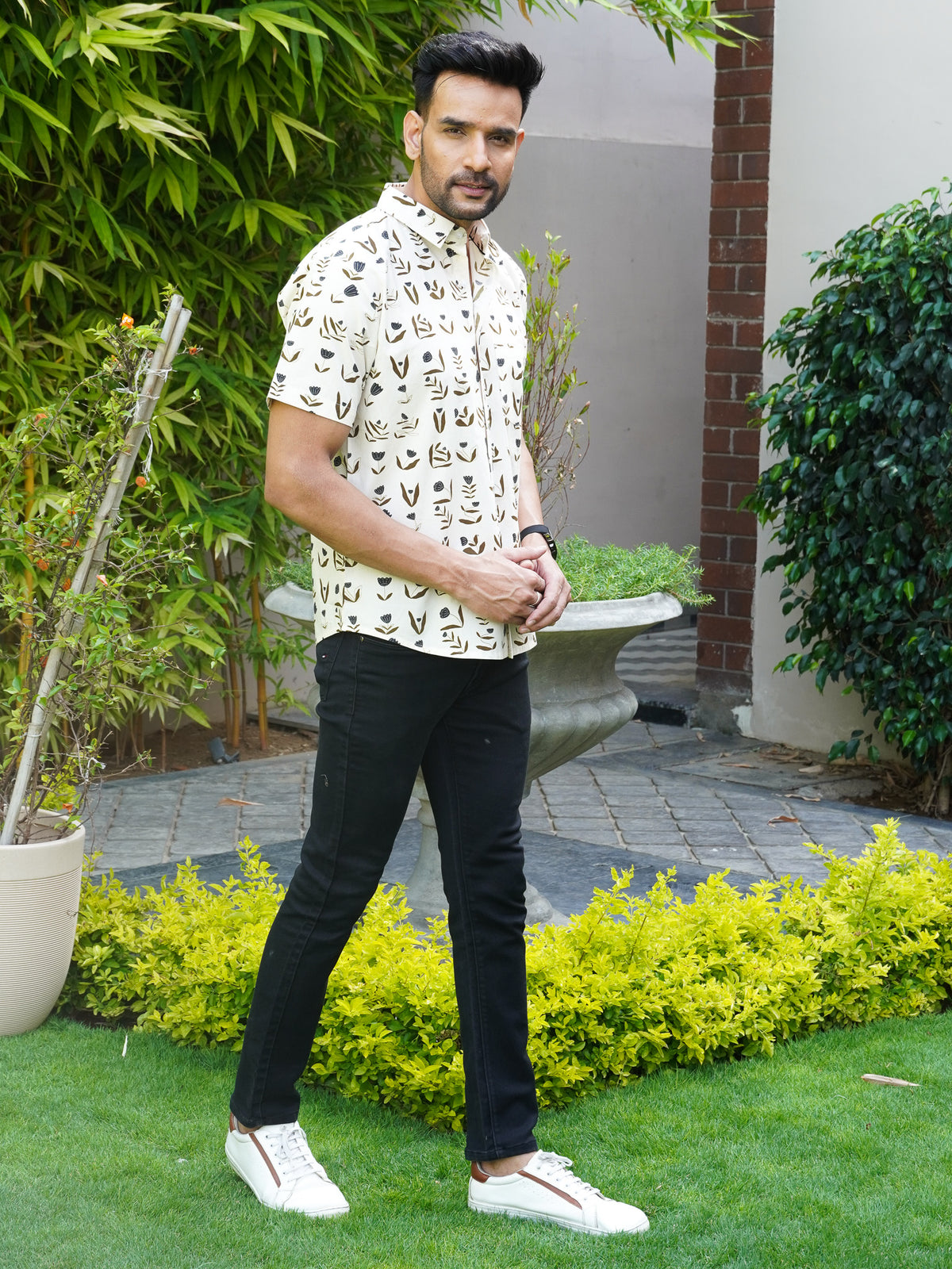 Model wearing a beige floral printed cotton half sleeve shirt