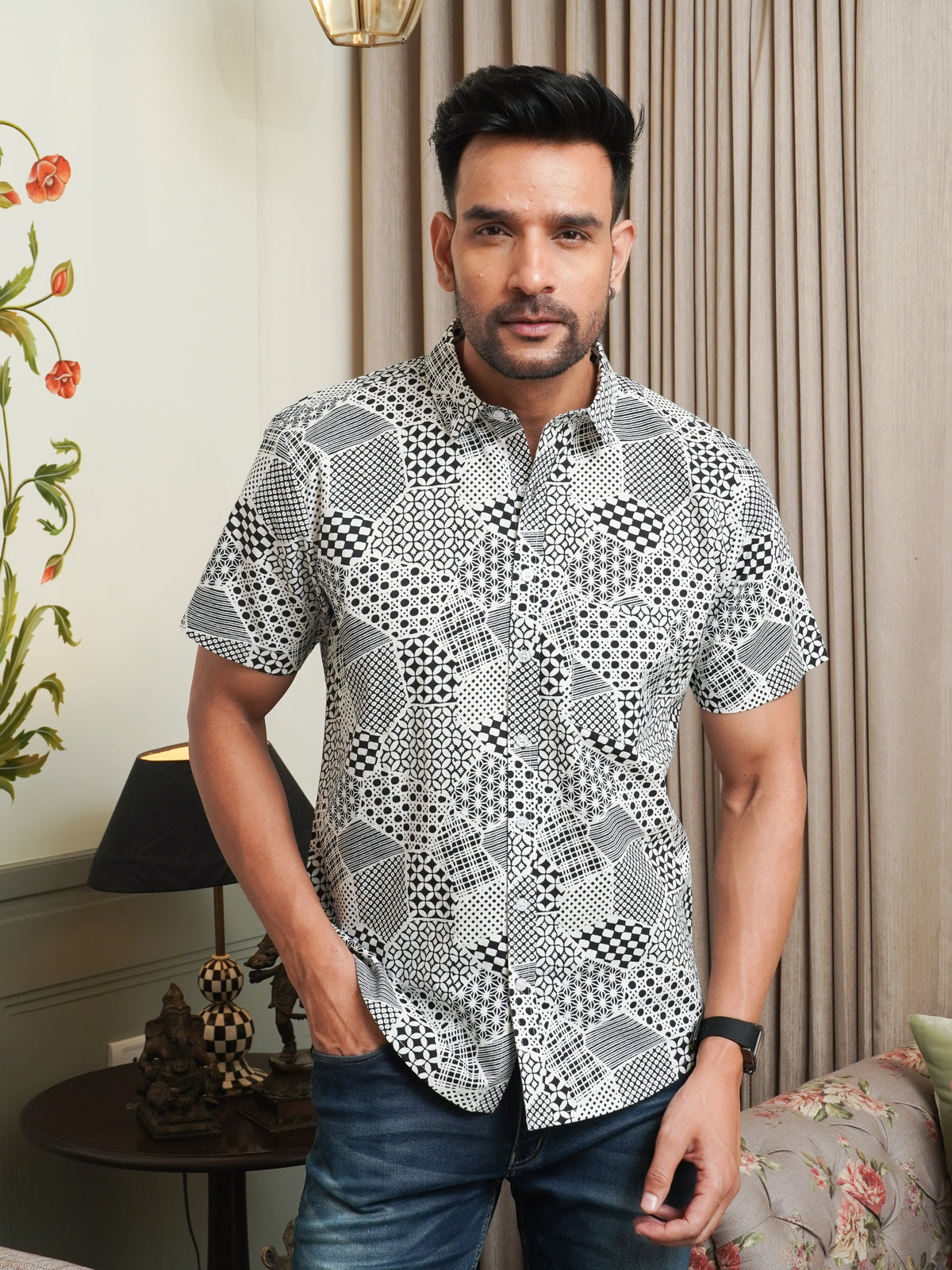 Model wearing a black abstract geometric printed cotton half sleeve shirt