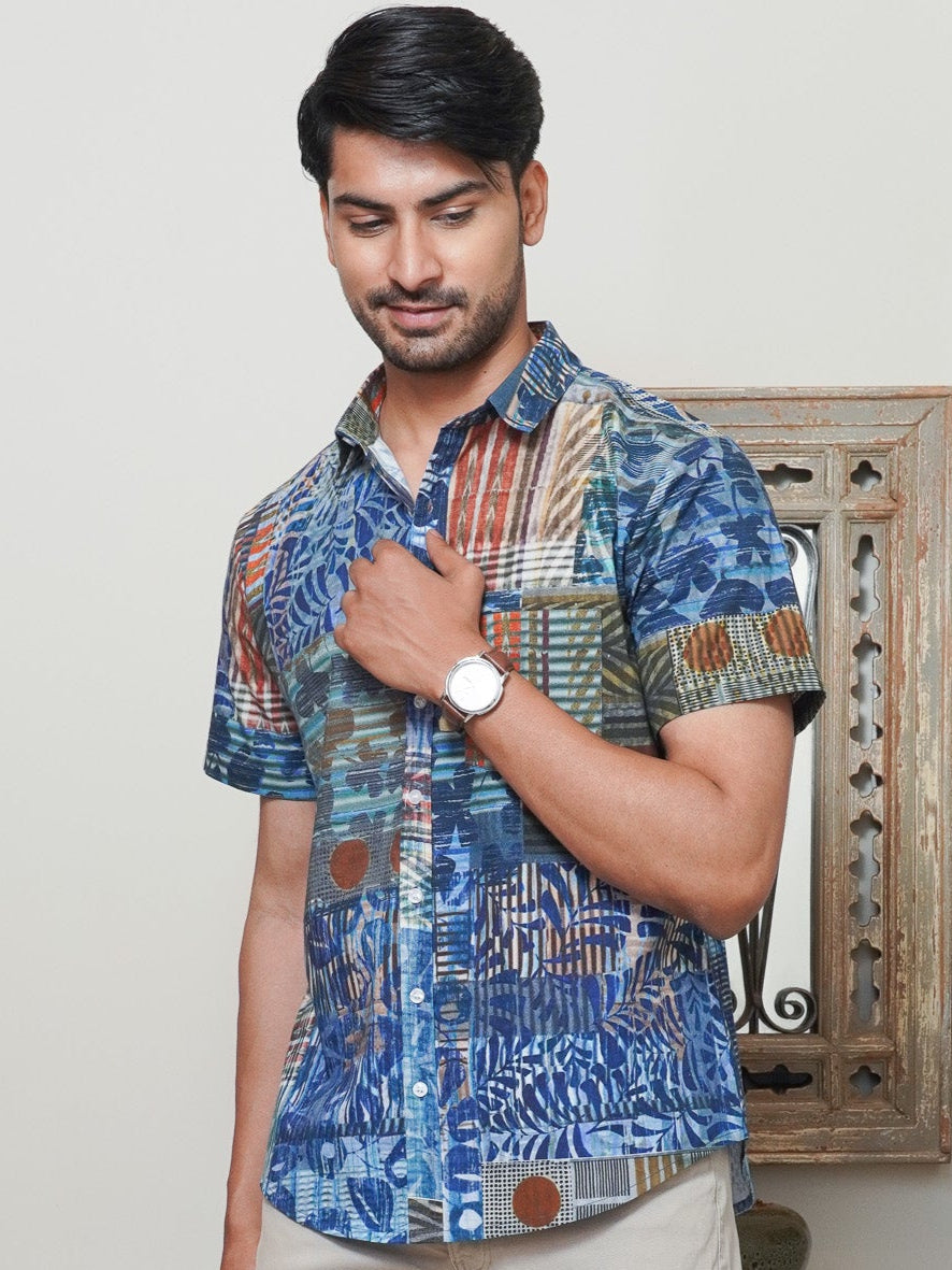 Model wearing a blue geometric abstract printed cotton half sleeve shirt