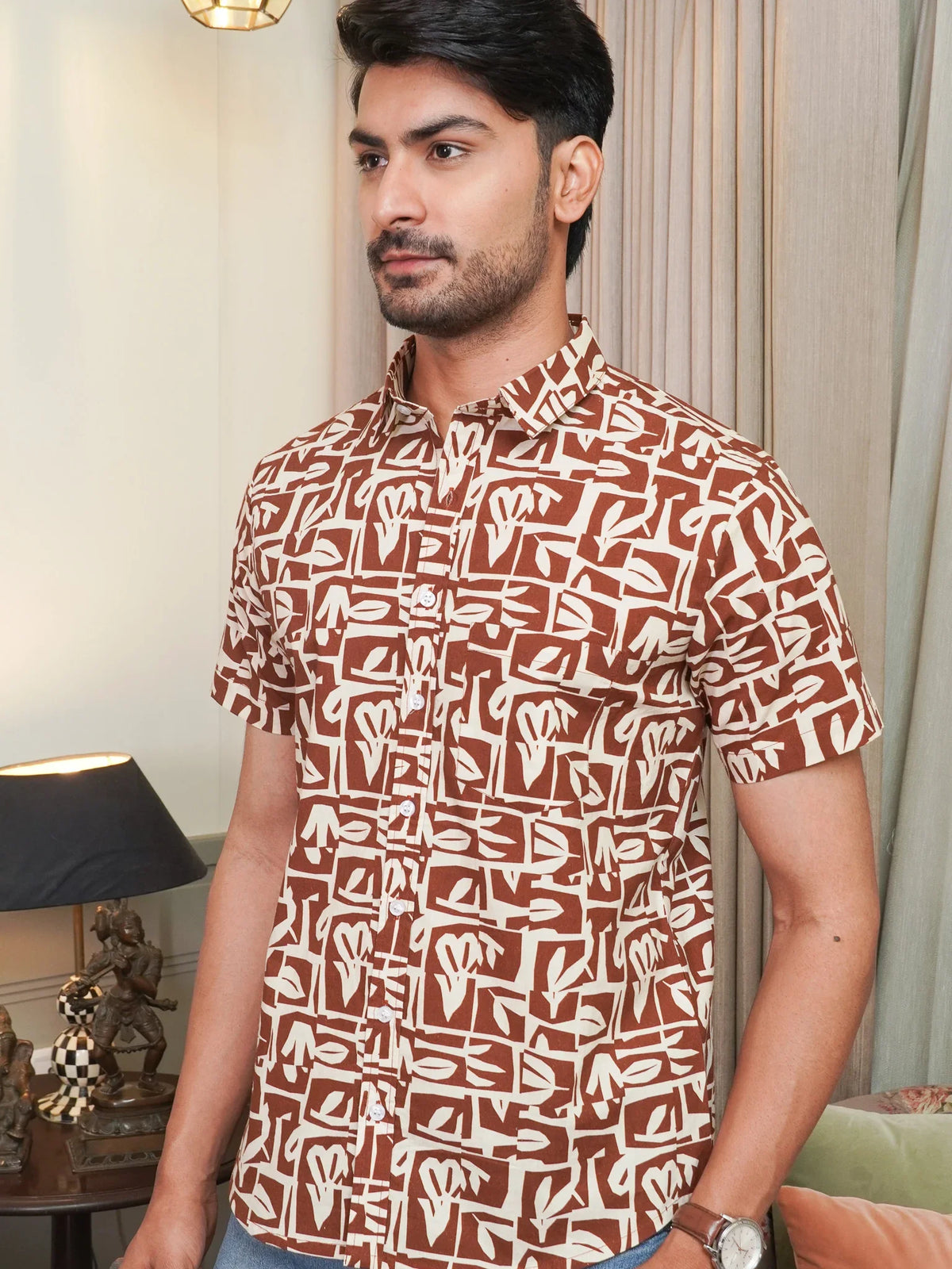Model wearing a brown abstract printed cotton half sleeve shirt