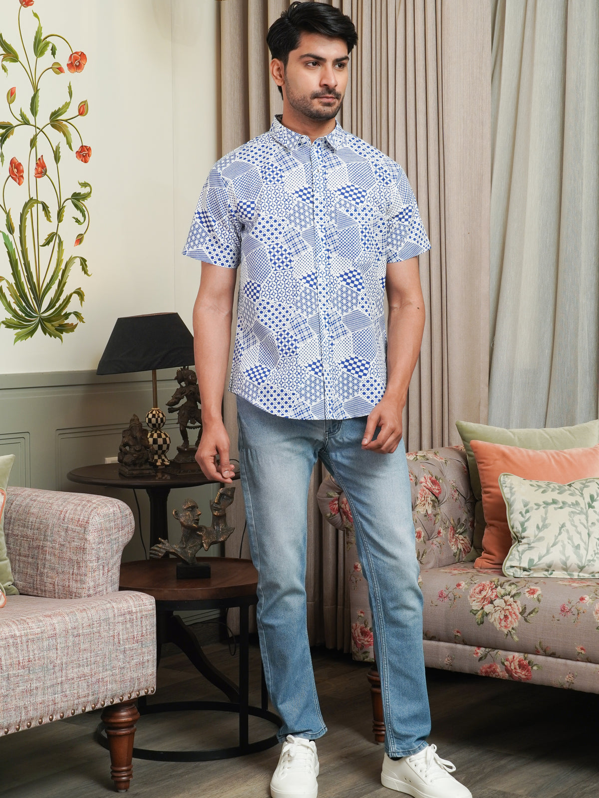 Model wearing a blue abstract geometric printed cotton half sleeve shirt