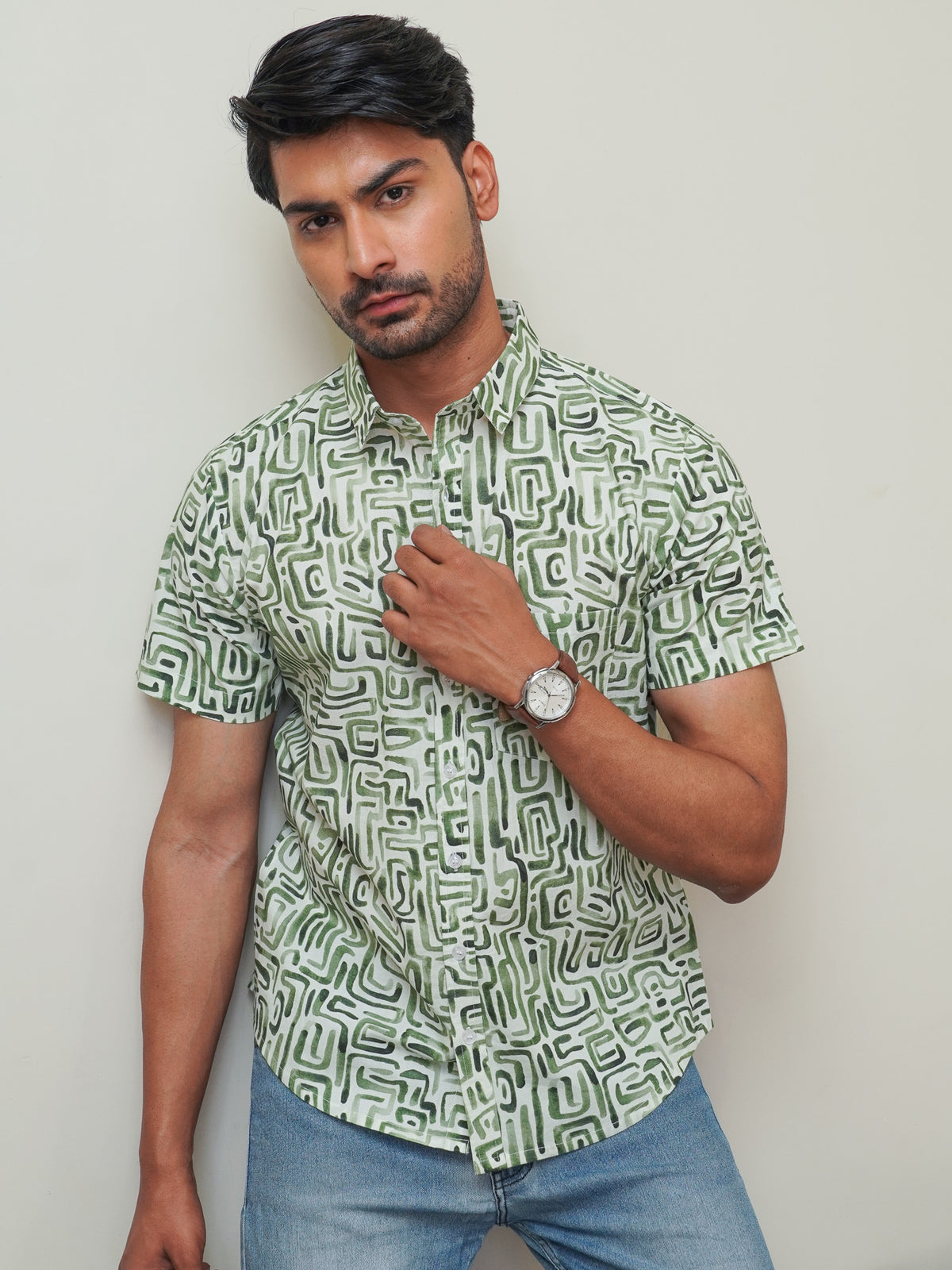 Model wearing a green abstract maze printed cotton half sleeve shirt
