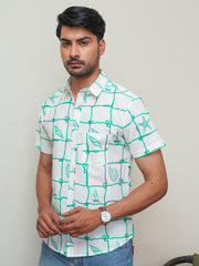 Model wearing a green box abstract printed cotton half sleeve shirt