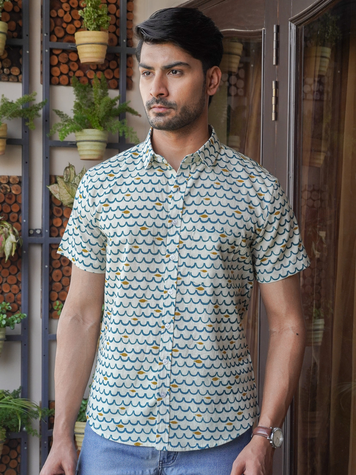 Model wearing a green floral printed cotton half sleeve shirt