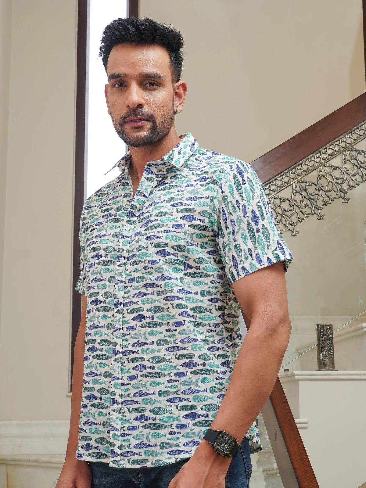 Model wearing a green fish printed cotton half sleeve shirt
