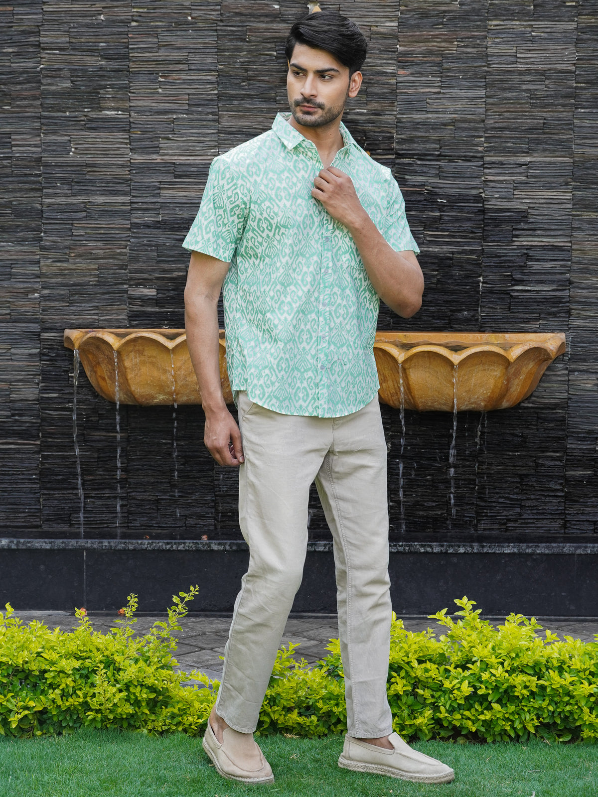 Side view of men’s green geometric half sleeve shirt