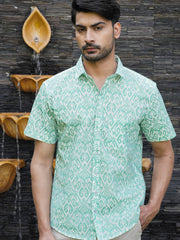 Model wearing a green geometric printed cotton half sleeve shirt