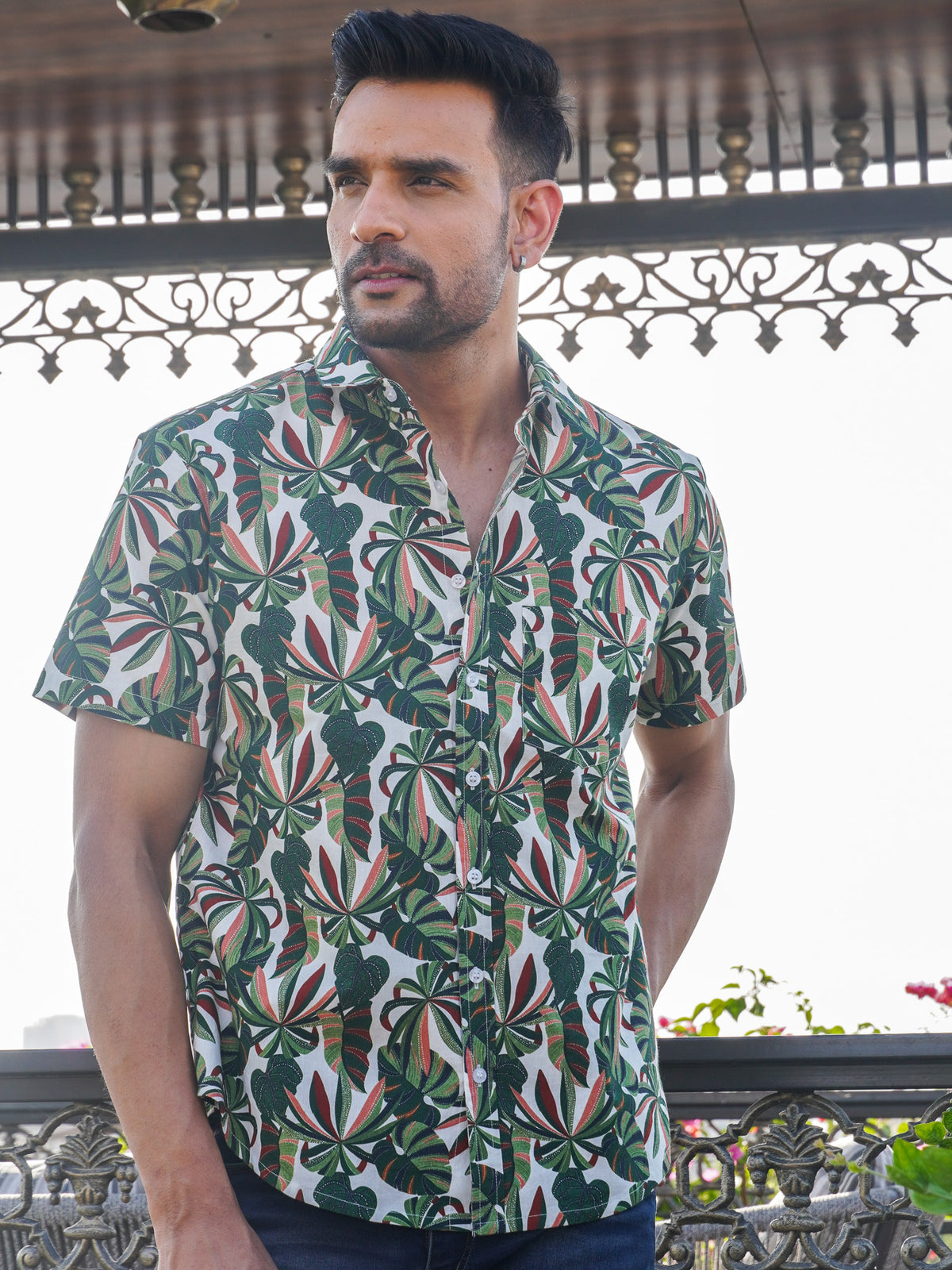 Model wearing a green tropical leaf printed cotton shirt