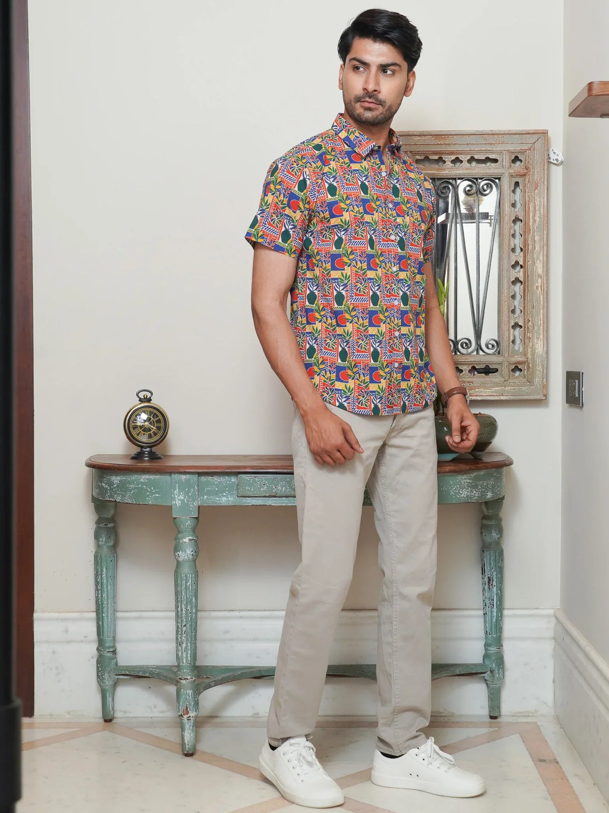 Model wearing a multicolor geometric printed cotton half sleeve shirt
