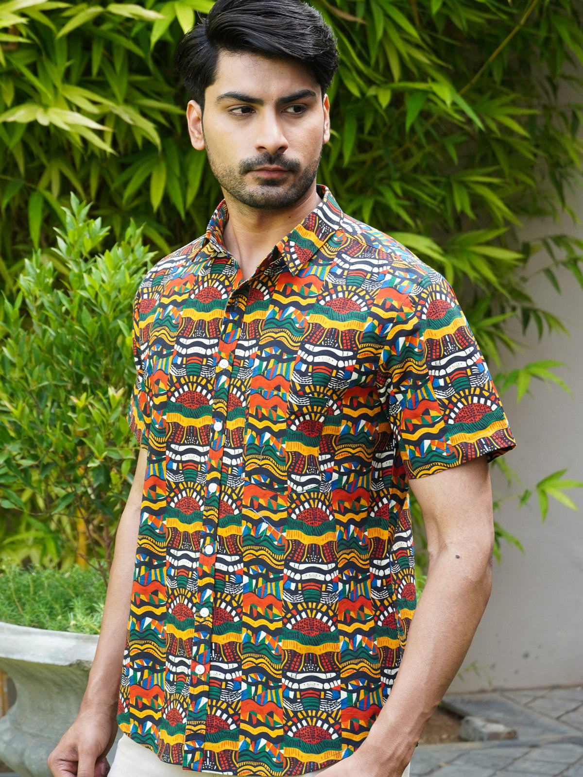 Model wearing a multicolor Tribal Rhythm printed cotton half sleeve shirt