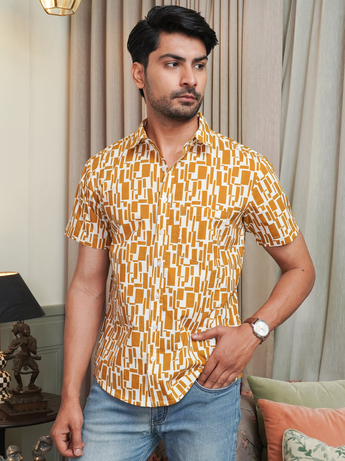 Model wearing a mustard abstract printed cotton half sleeve shirt