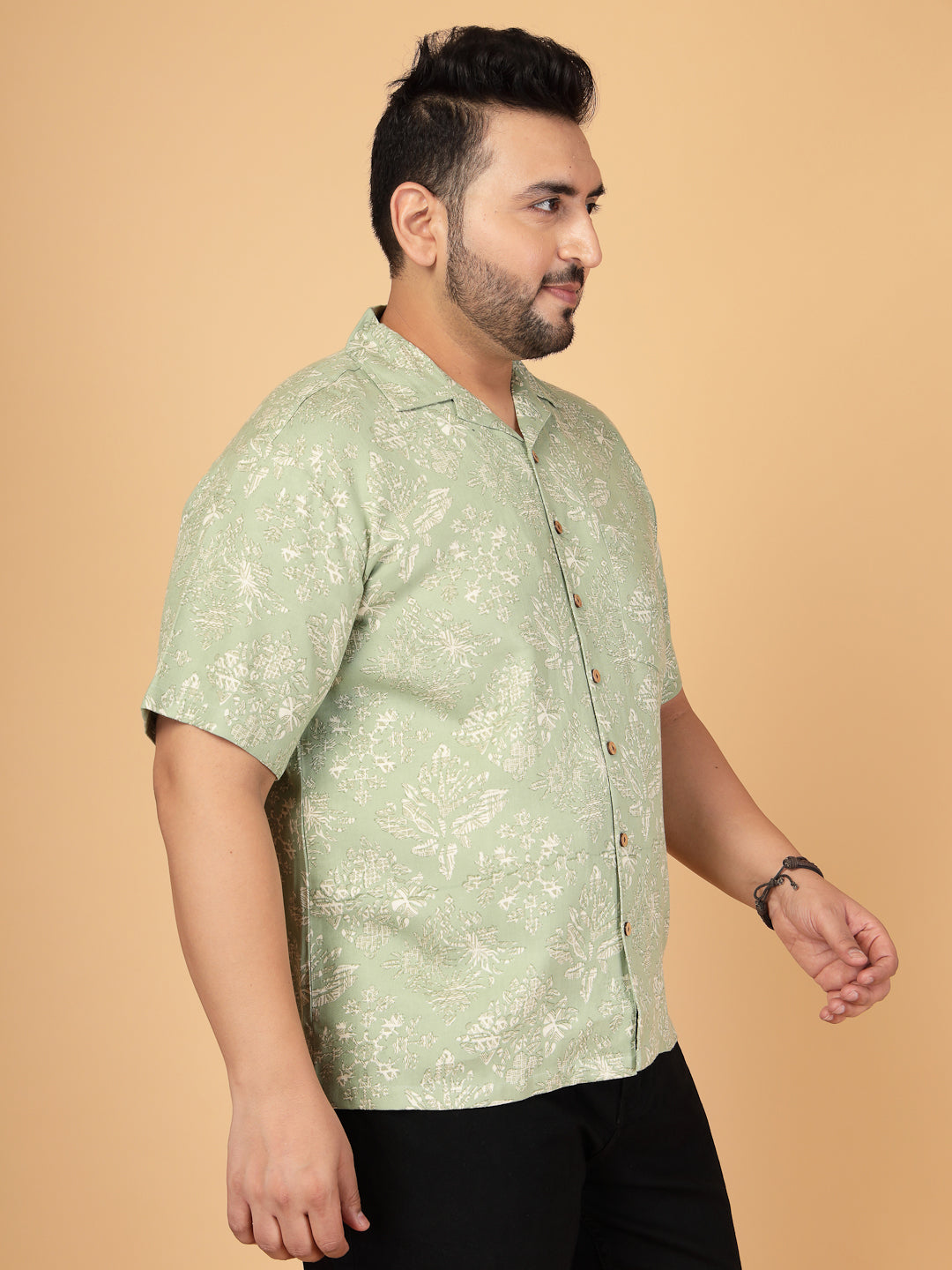 Plus-size man wearing a sage green botanical rayon twill shirt