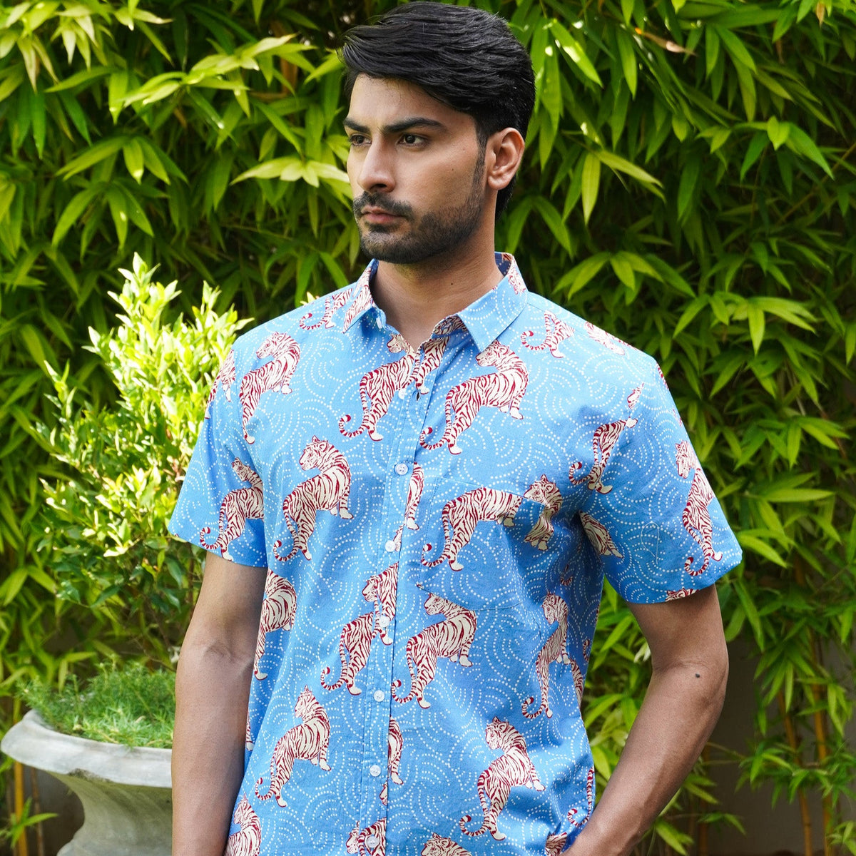 Model wearing a sky blue leopard printed cotton half sleeve shirt