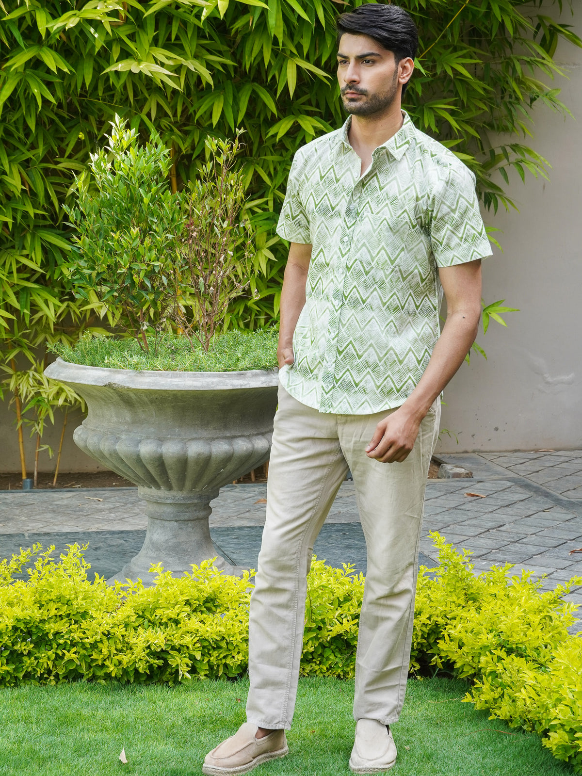 Model wearing a green zigzag printed cotton half sleeve shirt