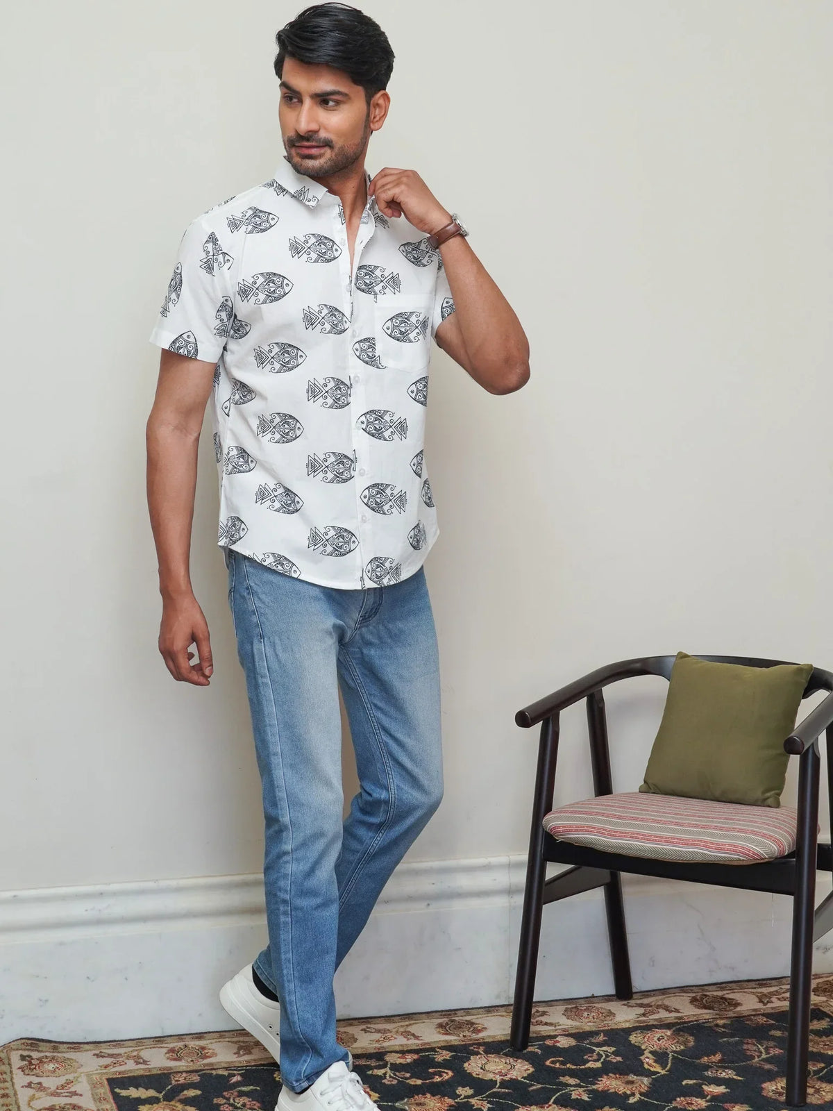 Model wearing a white cotton shirt with bold black fish print