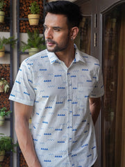 Model wearing a white cotton shirt with blue abstract print