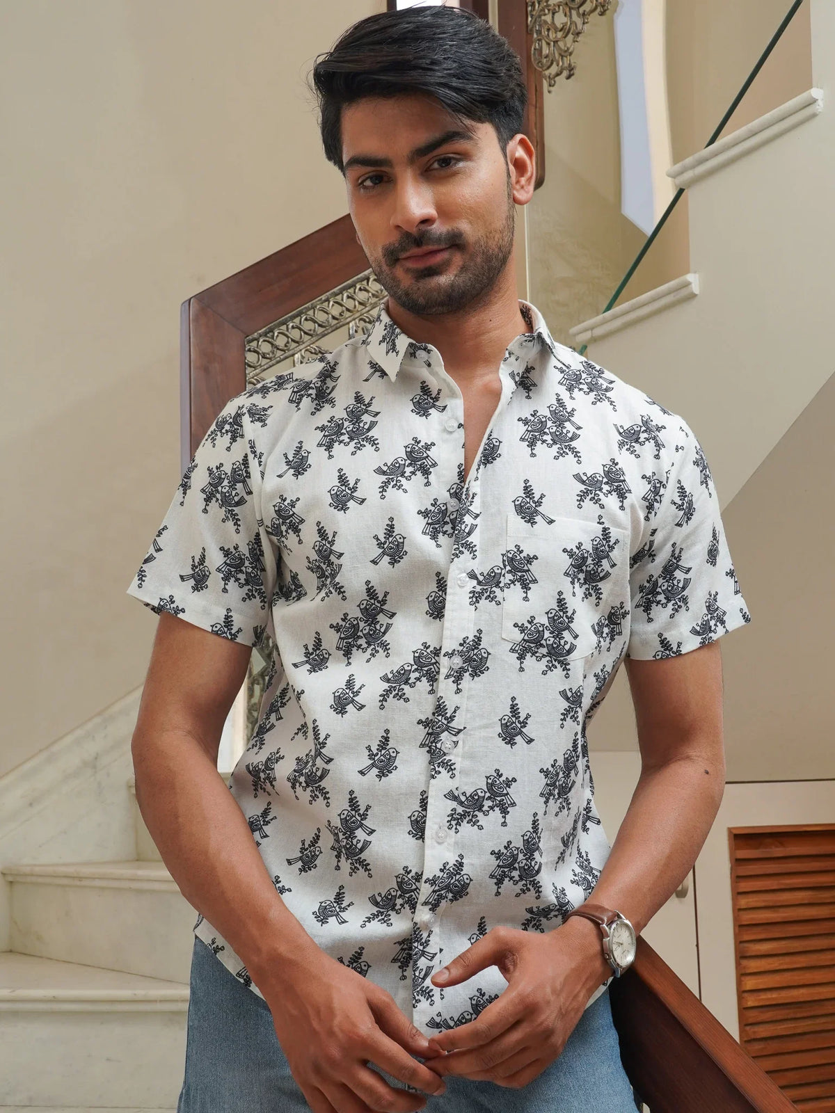 Model wearing a white cotton shirt with blue floral print