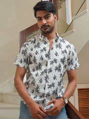 Model wearing a white cotton shirt with blue floral print