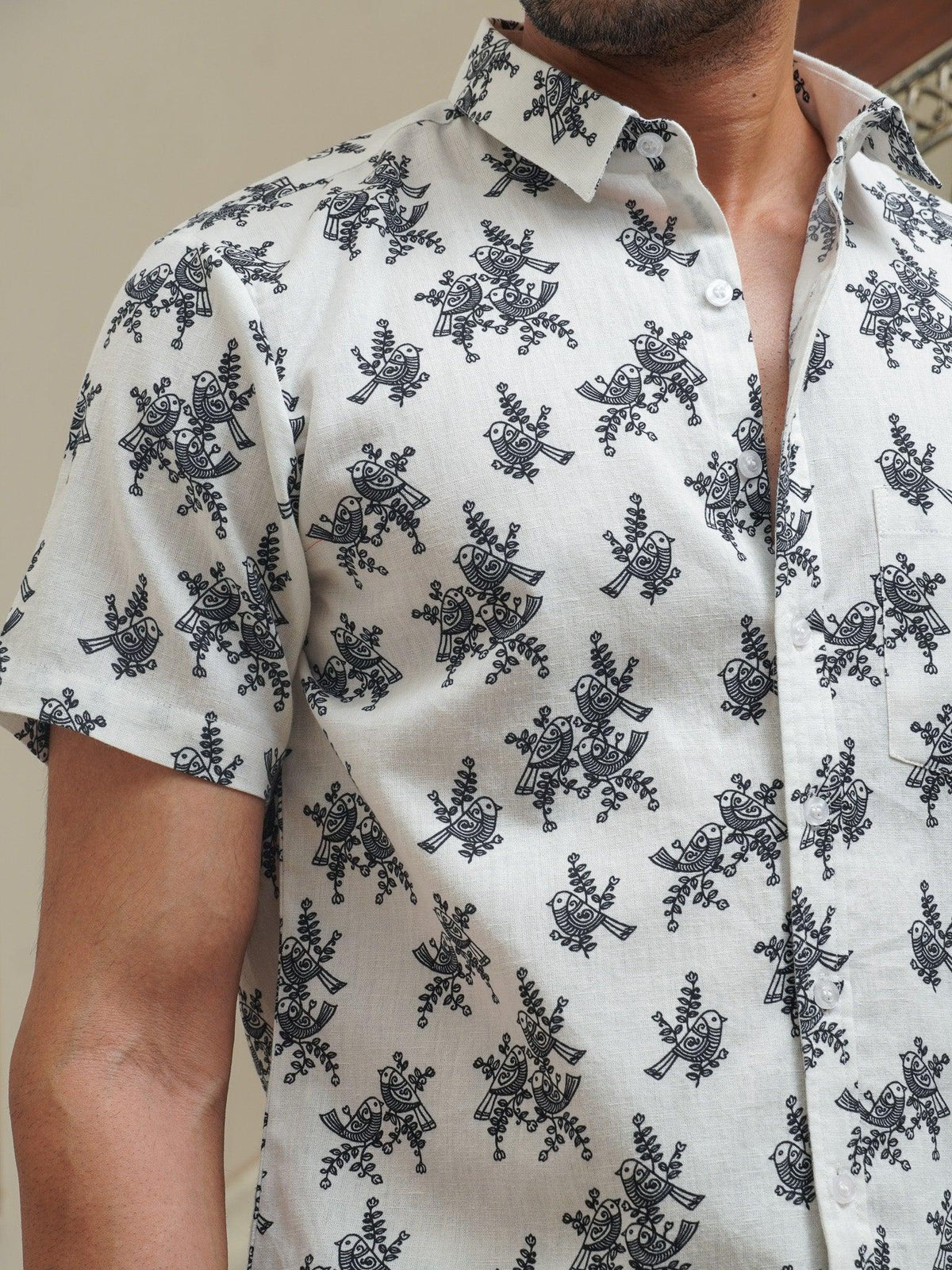 Side view of men’s white blue floral half sleeve shirt