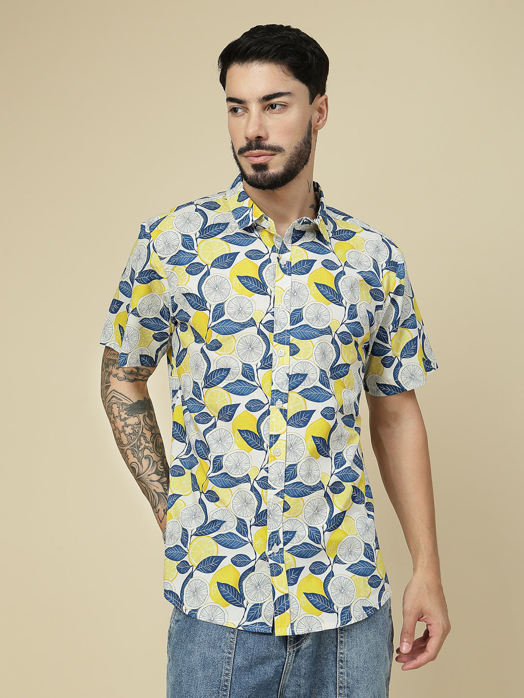 Model wearing a white lemon and leaf printed half sleeve shirt
