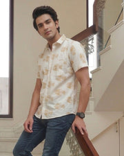 Model wearing a white cotton shirt with yellow fish print