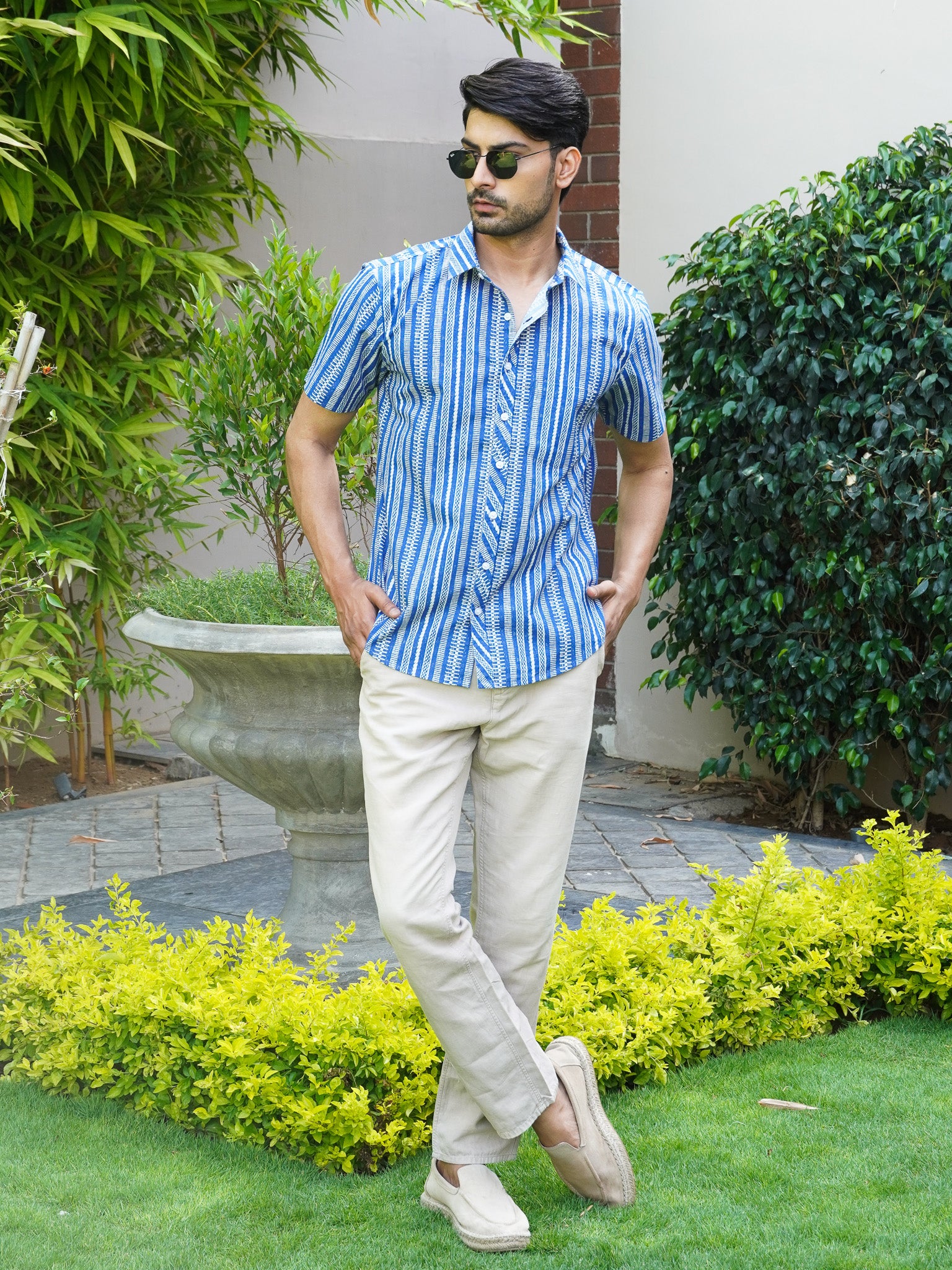Model wearing men’s blue abstract striped half sleeve shirt