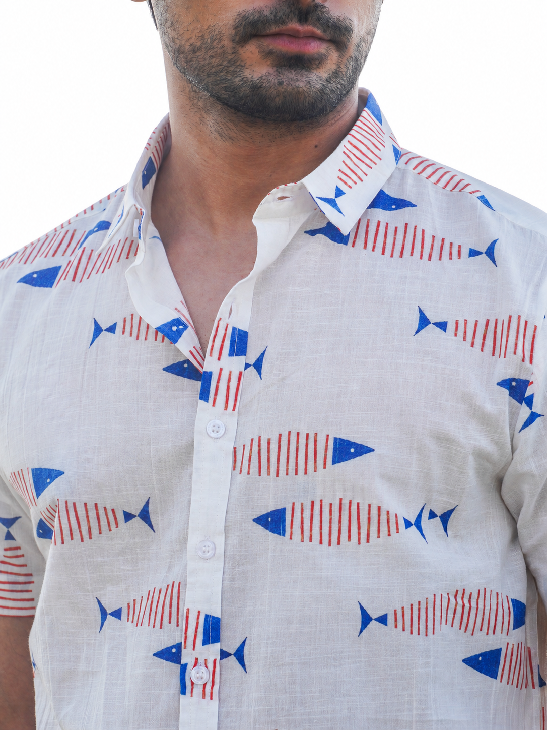 Close-up of multicolor fish print on white cotton shirt
