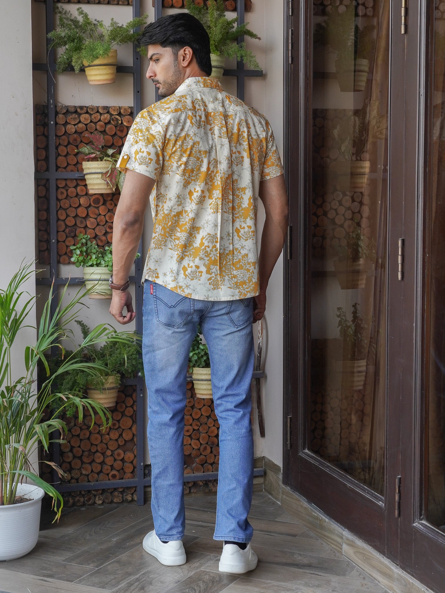 Back view of men’s mustard floral print regular fit shirt