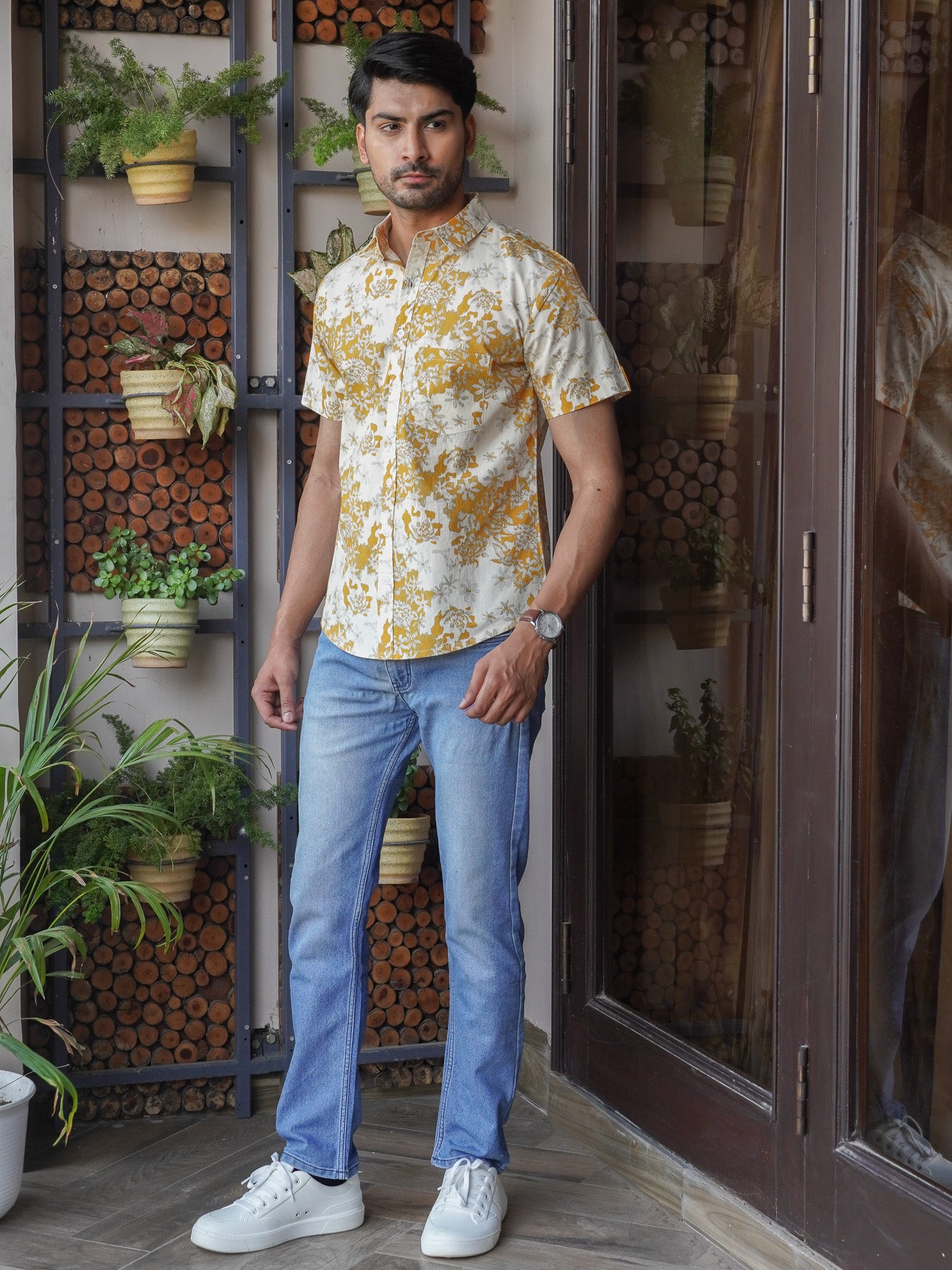 Model wearing men’s mustard floral print half sleeve shirt