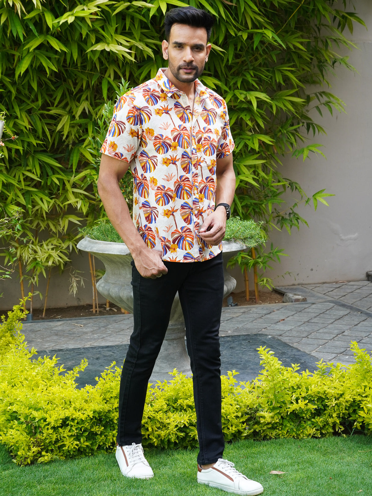 Model wearing a tropical multicolor leaf printed cotton shirt