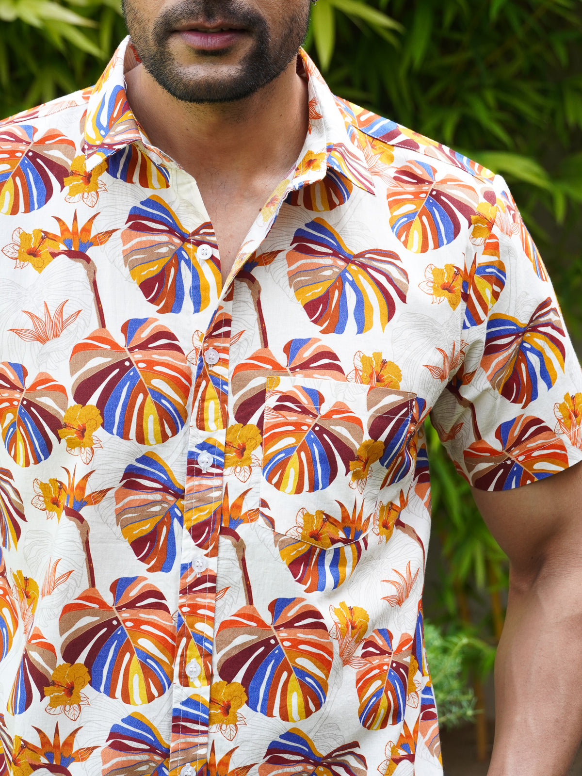 Close-up of orange blue purple and mustard tropical leaf motifs