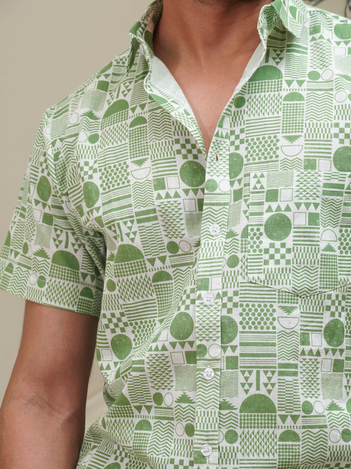 Close-up of green grids circles stripes and geometric motifs