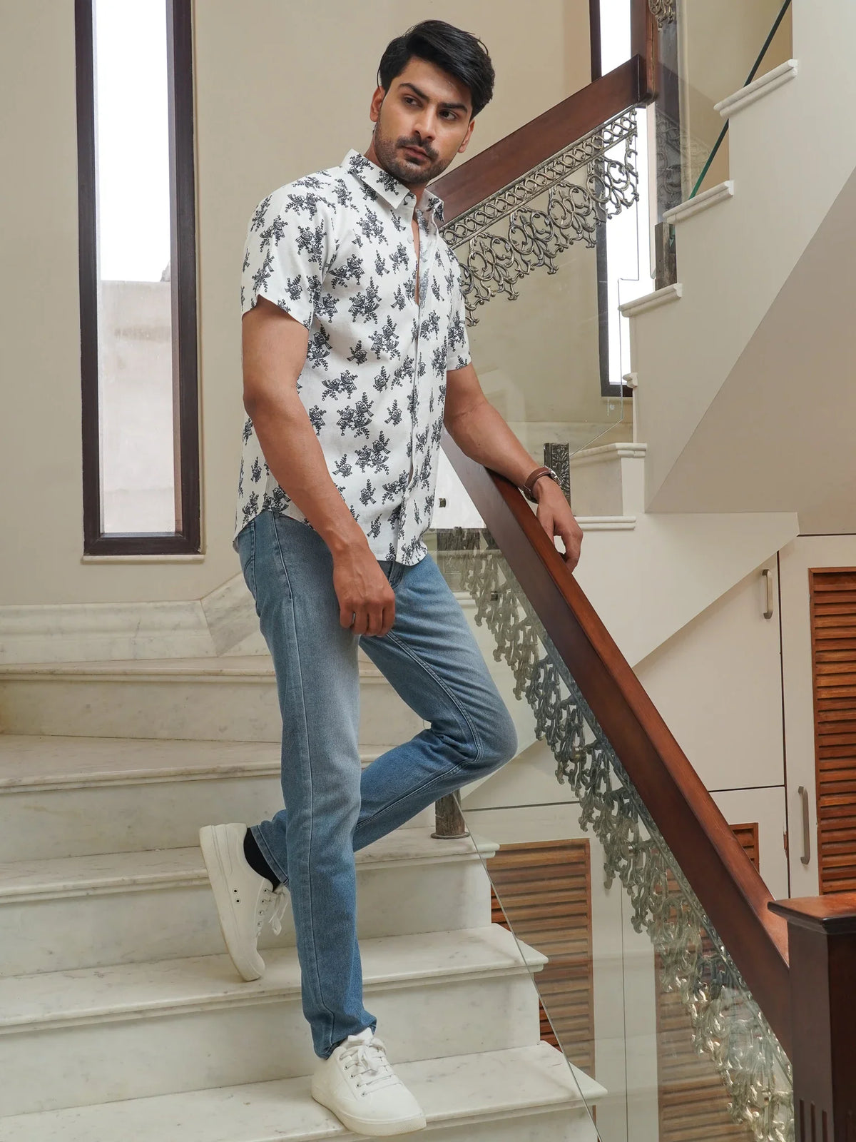 Model wearing a white cotton shirt with blue floral print