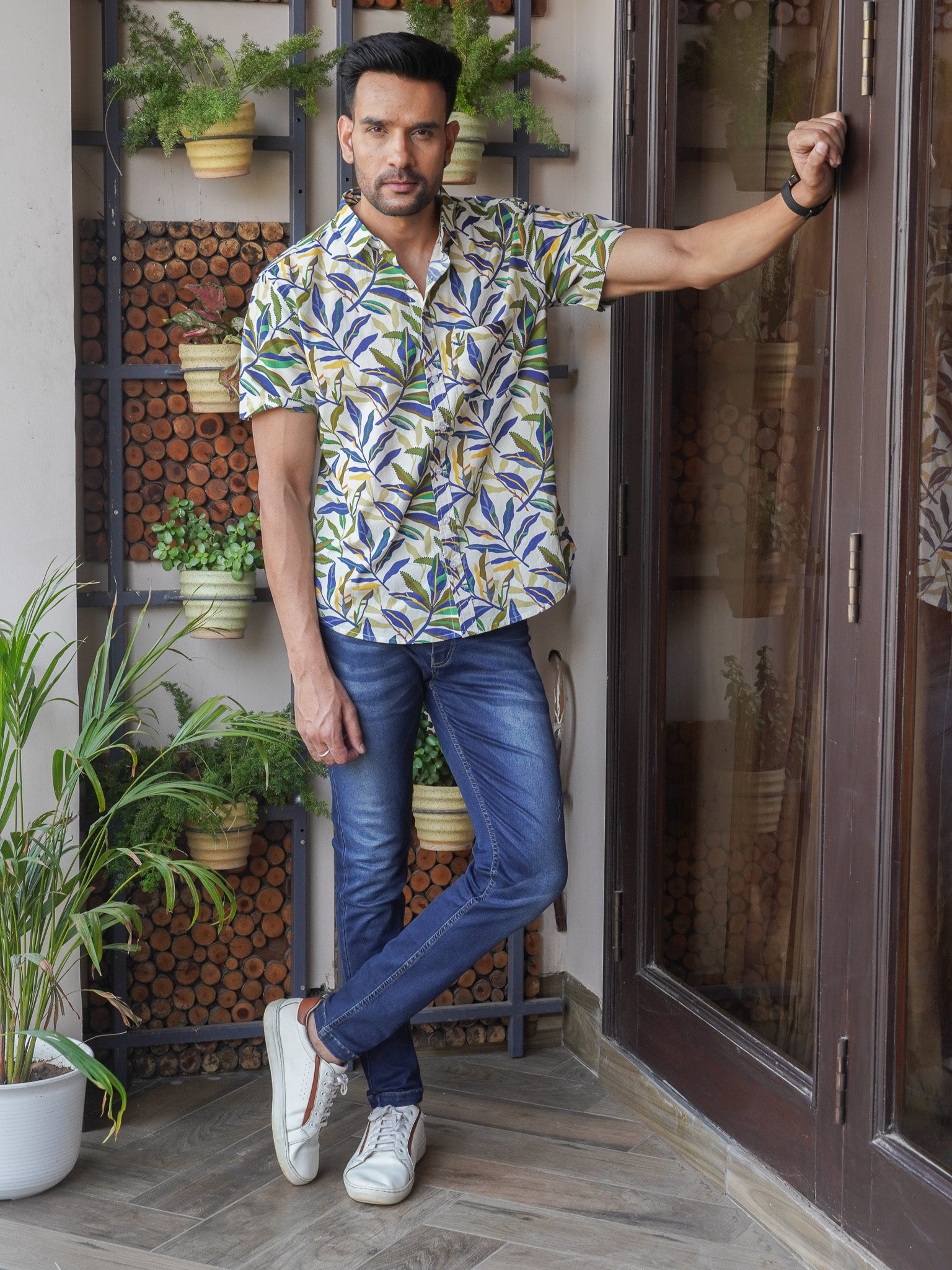 Model wearing men’s white tropical leaf print half sleeve shirt