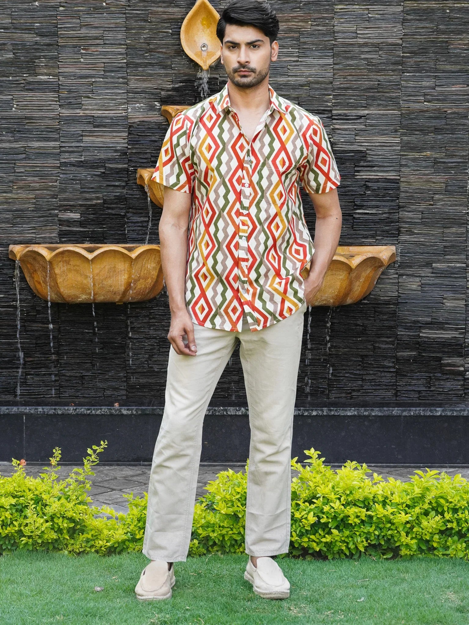 Model wearing men’s white multicolour abstract print half sleeve shirt