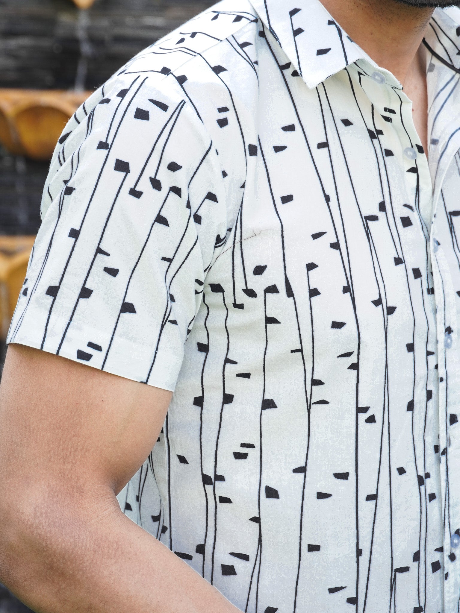 Side view of men’s white black abstract print half sleeve shirt