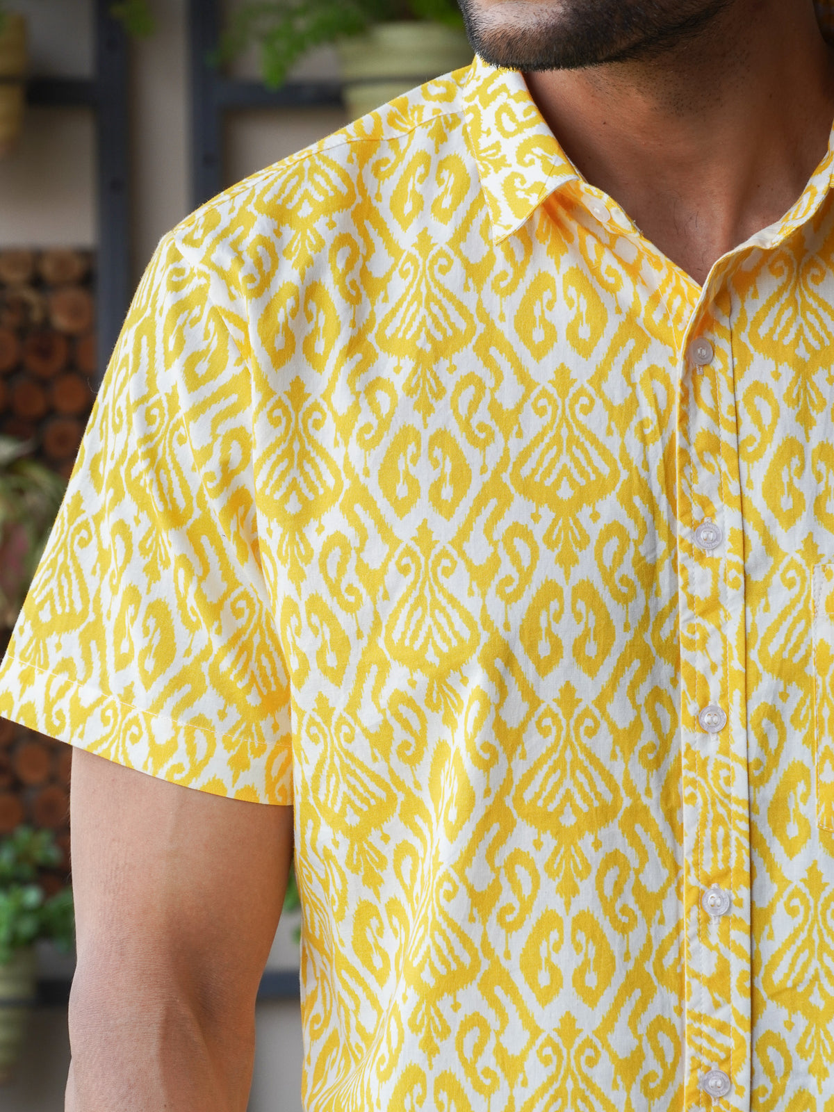 Close-up of yellow abstract geometric motifs on light fabric